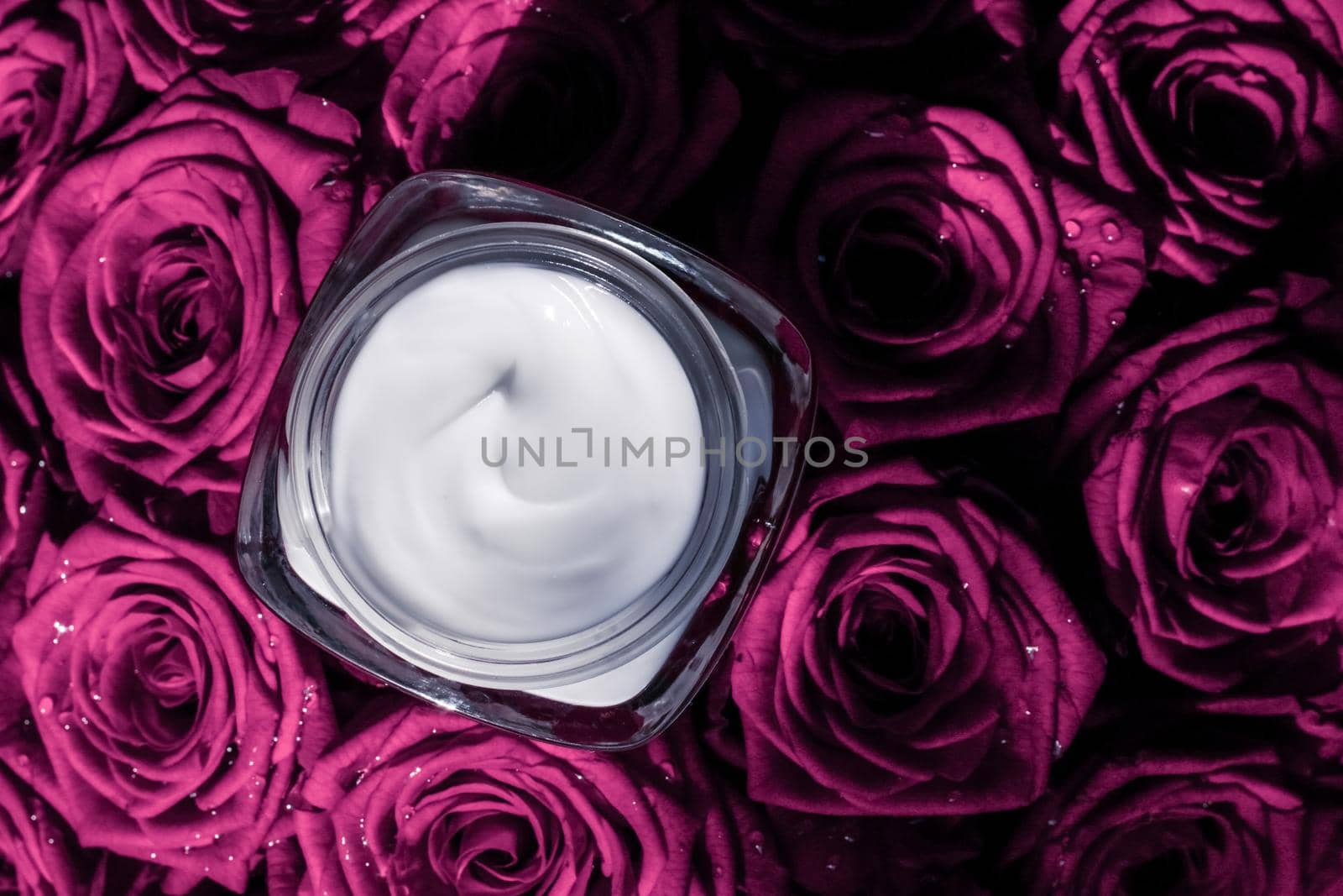 Face cream skin moisturizer on pink roses flowers, luxury skincare cosmetic product on floral background as beauty brand holiday flatlay design by Anneleven