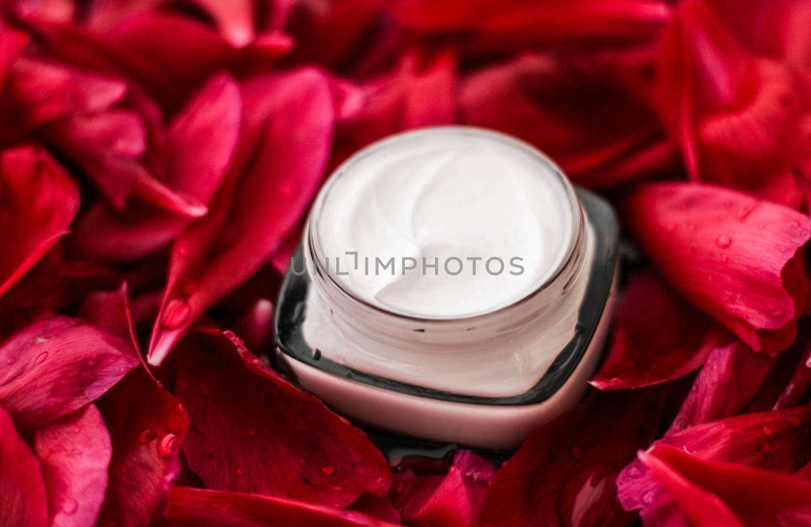 Sensitive skincare moisturizer cream on red flower petals and water background, natural science for skin by Anneleven