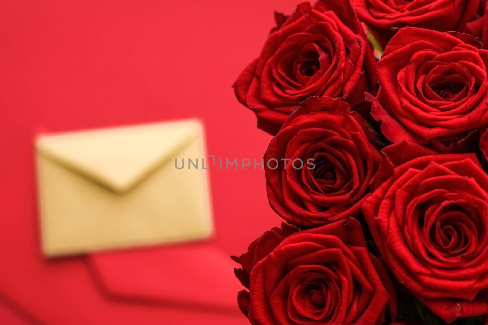 Love letter and flower delivery service on Valentines Day, luxury bouquet of red roses and card envelopes on red background by Anneleven