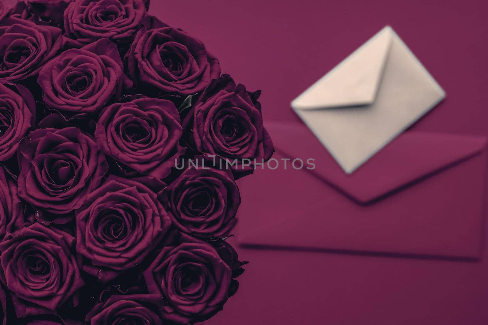 Holidays gift, floral present and happy relationship concept - Love letter and flowers delivery on Valentines Day, luxury bouquet of roses and card on wine background for romantic holiday design