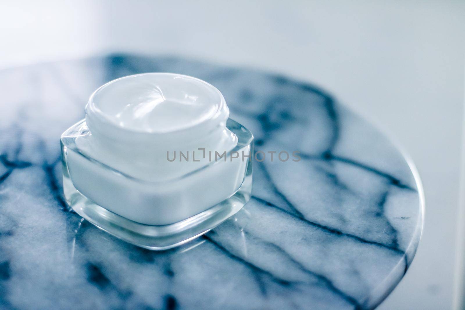 Moisturizing beauty face cream on blue marble stone, skincare and spa cosmetics by Anneleven