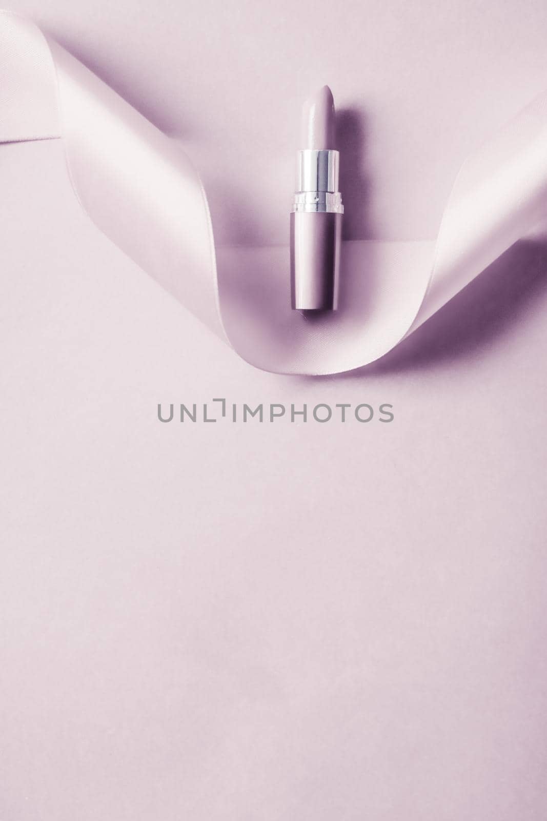 Luxury lipstick and silk ribbon on blush purple holiday background, make-up and cosmetics flatlay for beauty brand product design by Anneleven