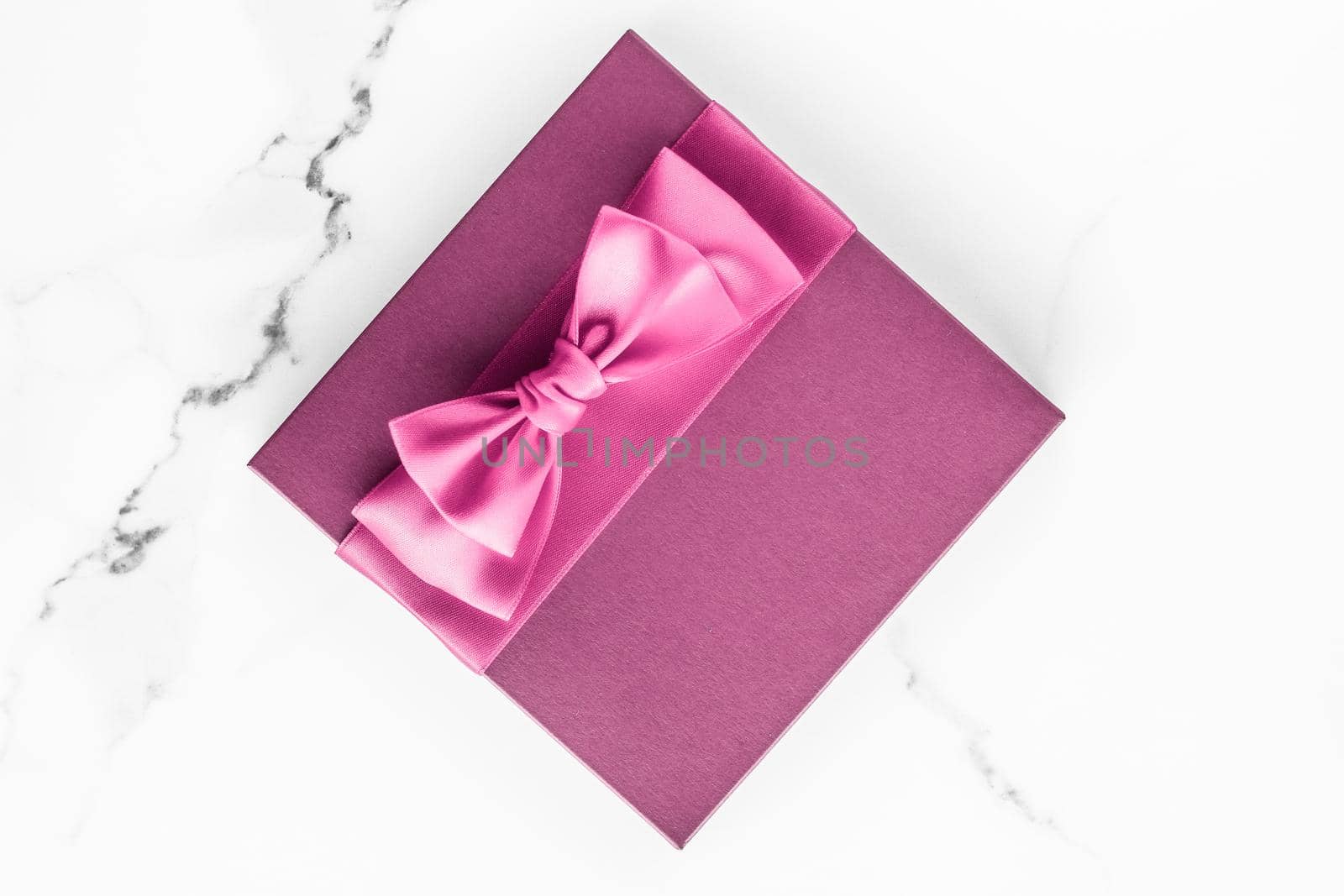 Birthday, wedding and girly branding concept - Pink gift box with silk bow on marble background, girl baby shower present and glamour fashion gift for luxury beauty brand, holiday flatlay art design