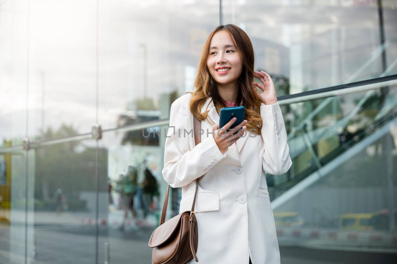 Portrait successful business woman smiling holding smartphone use application chat online in morning by Sorapop