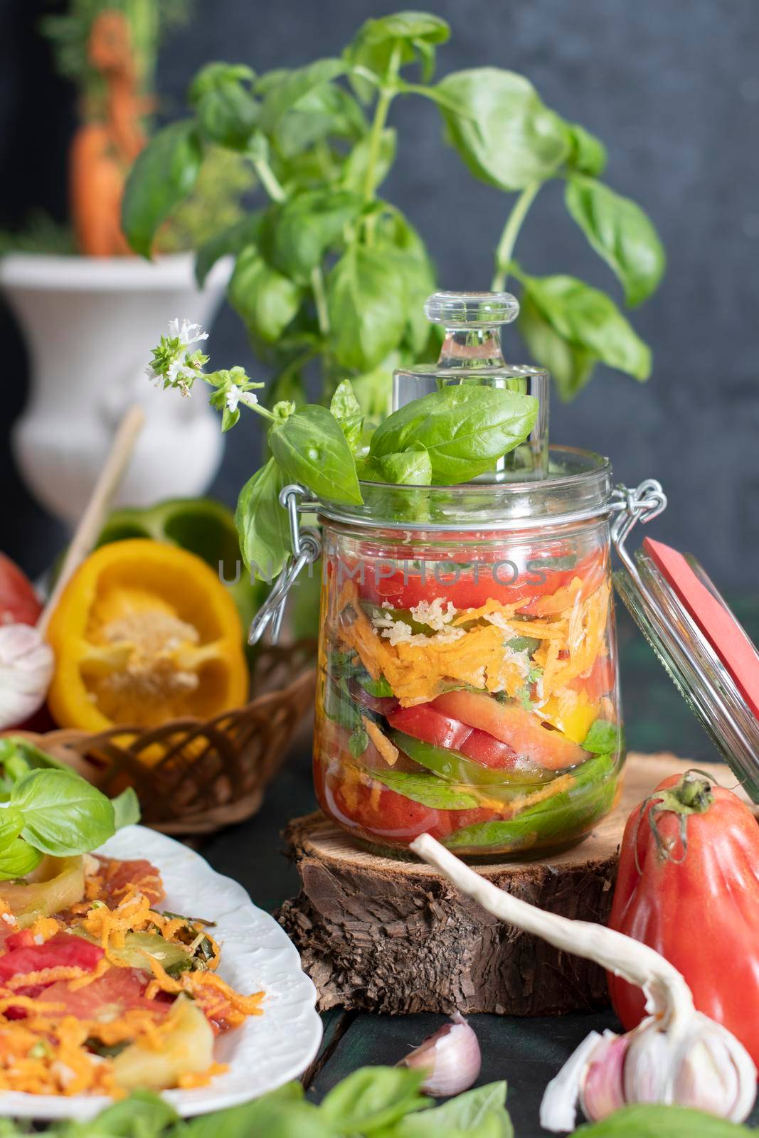 orange salad of paprika,tomatoes, carrots and basil for harvesting for the winter in a jar. High quality photo