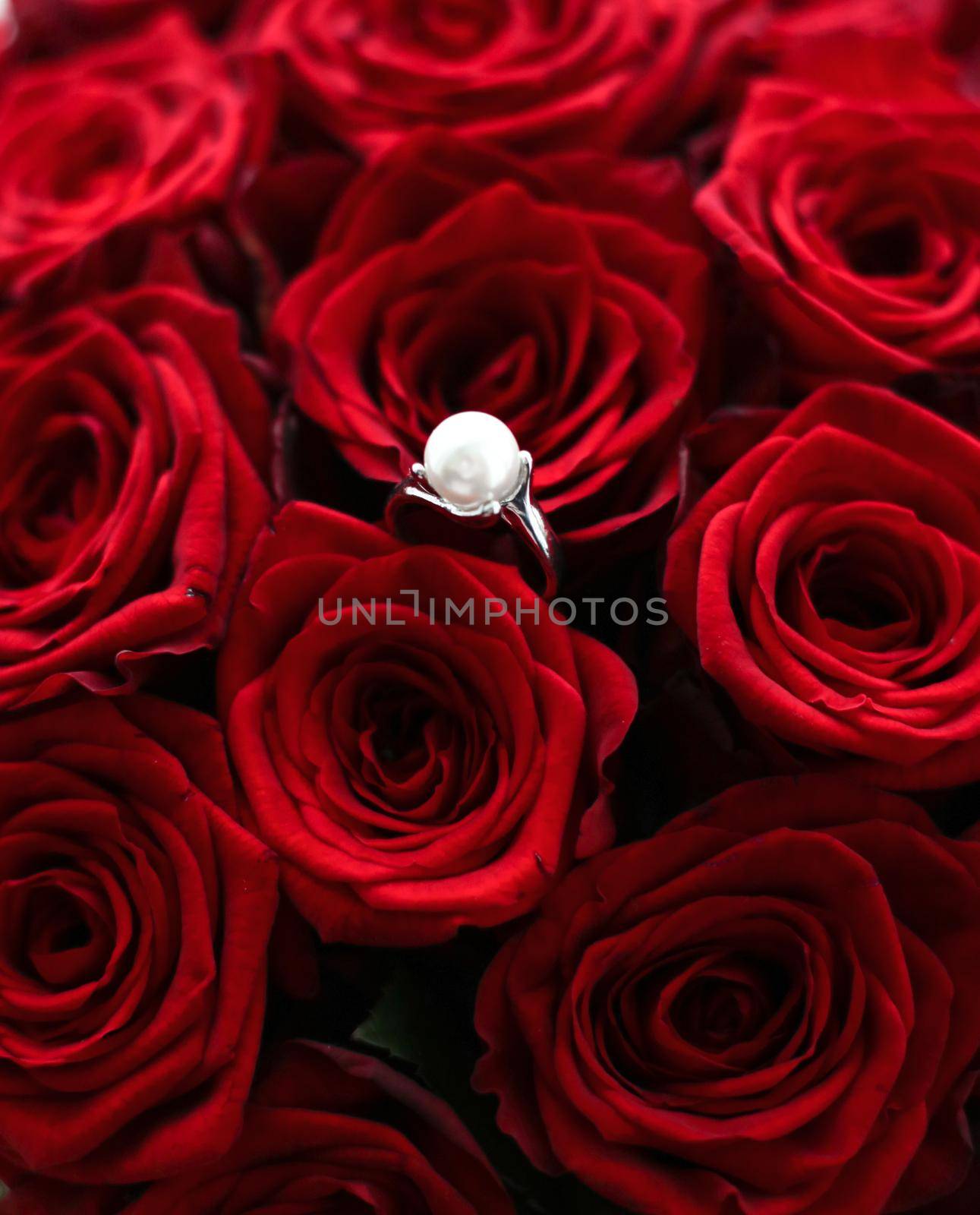 Gemstone jewellery, wedding present and engagement proposal concept - Beautiful white gold pearl ring and bouquet of red roses, luxury jewelry love gift on Valentines Day and romantic holidays