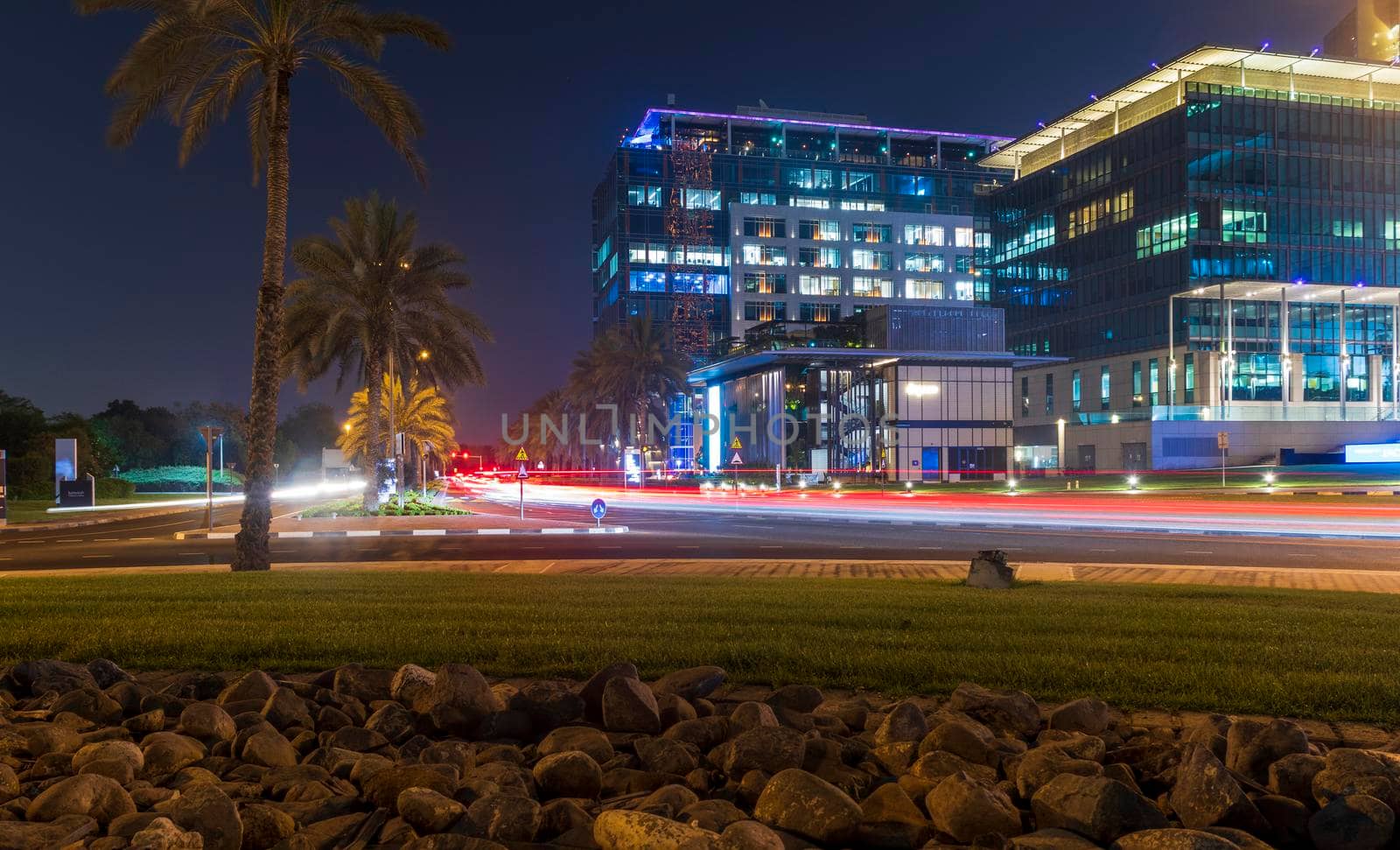 Dubai, UAE - 05.28.2021 Night street with light trails from the cars at Dubai International Financial center