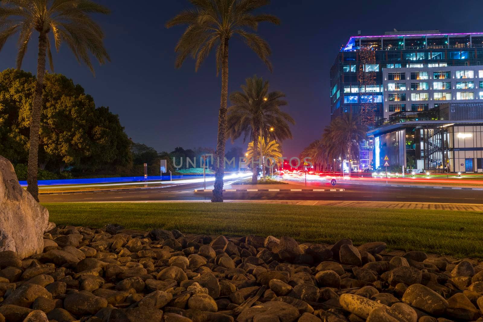 Dubai, UAE - 05.28.2021 Night street with light trails from the cars at Dubai International Financial center