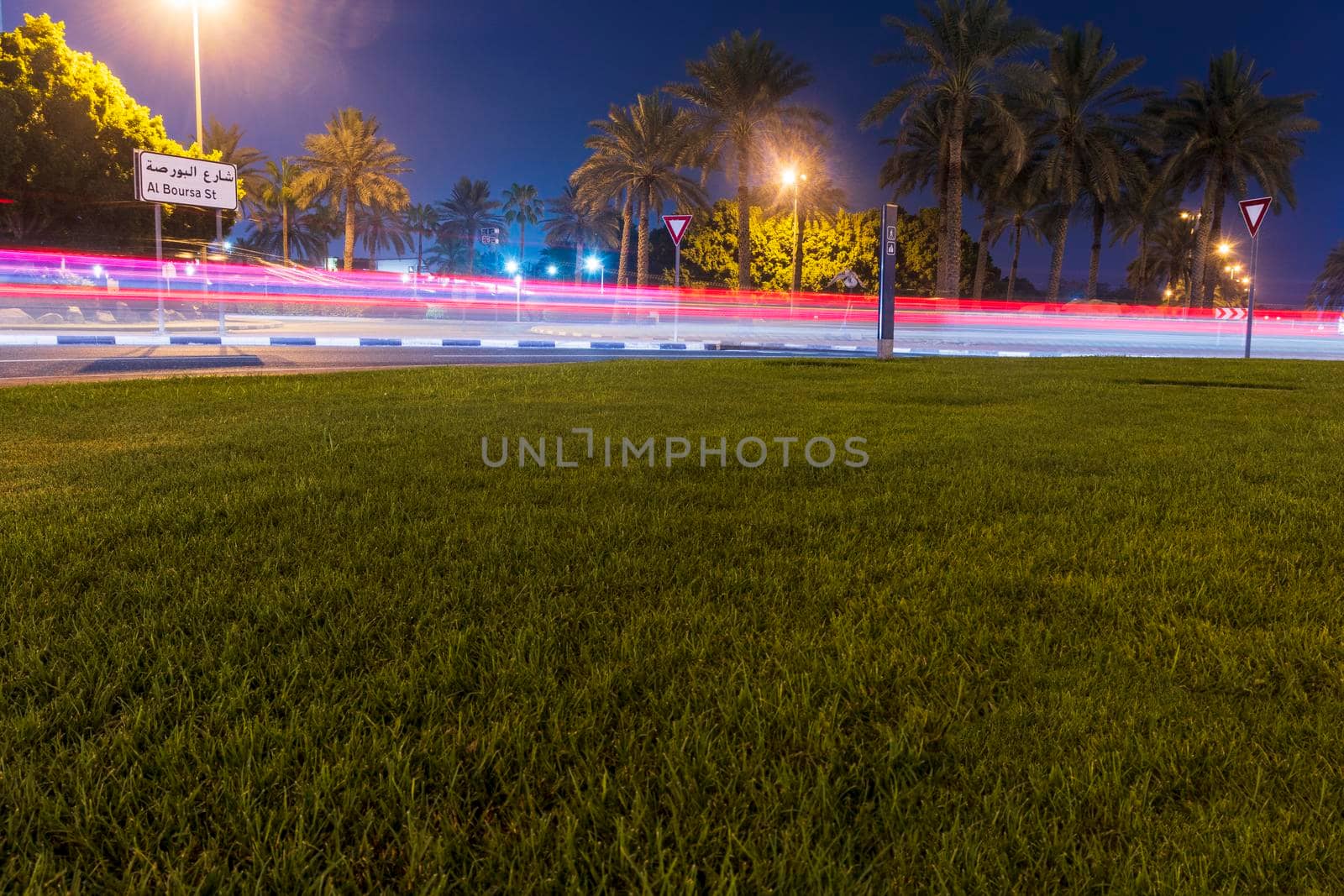 Dubai, UAE - 05.28.2021 Night street with light trails from the cars at Dubai International Financial center