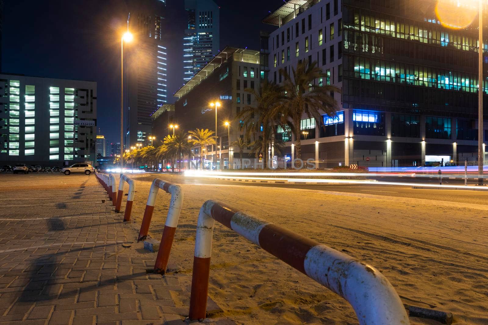 Dubai, UAE - 05.28.2021 Night street with light trails from the cars at Dubai International Financial center