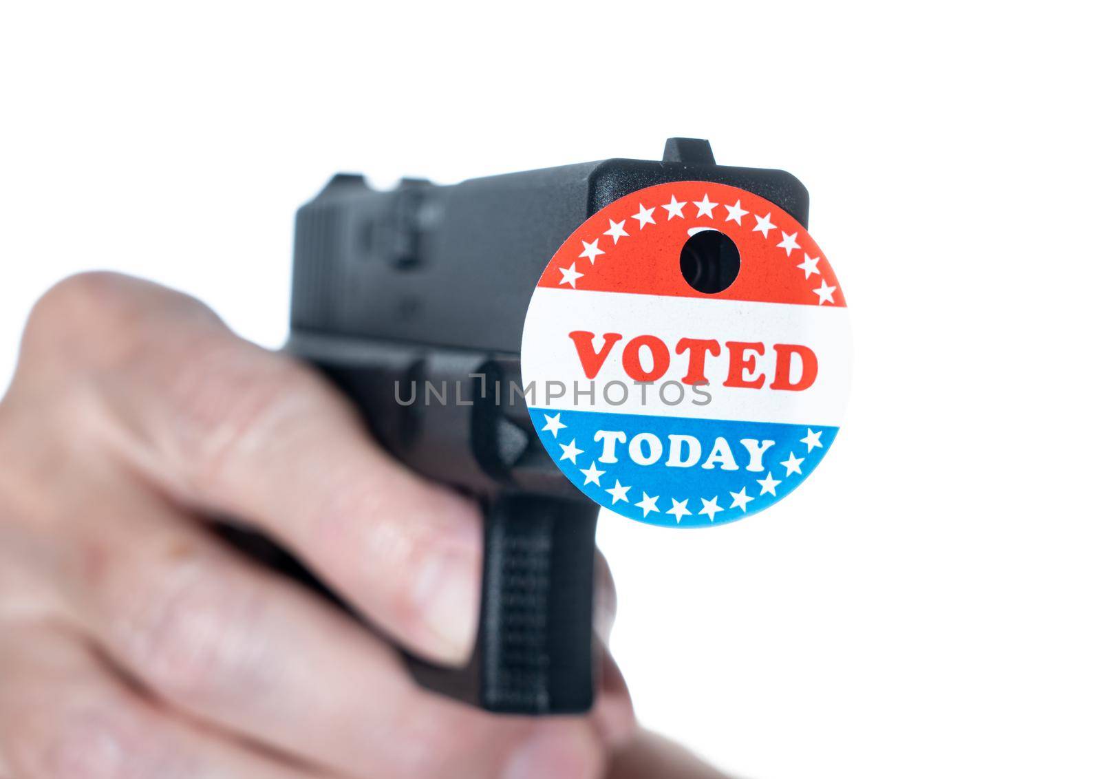 Concept for election violence with handgun decorated with I voted today sticker with hole made by fired bullet