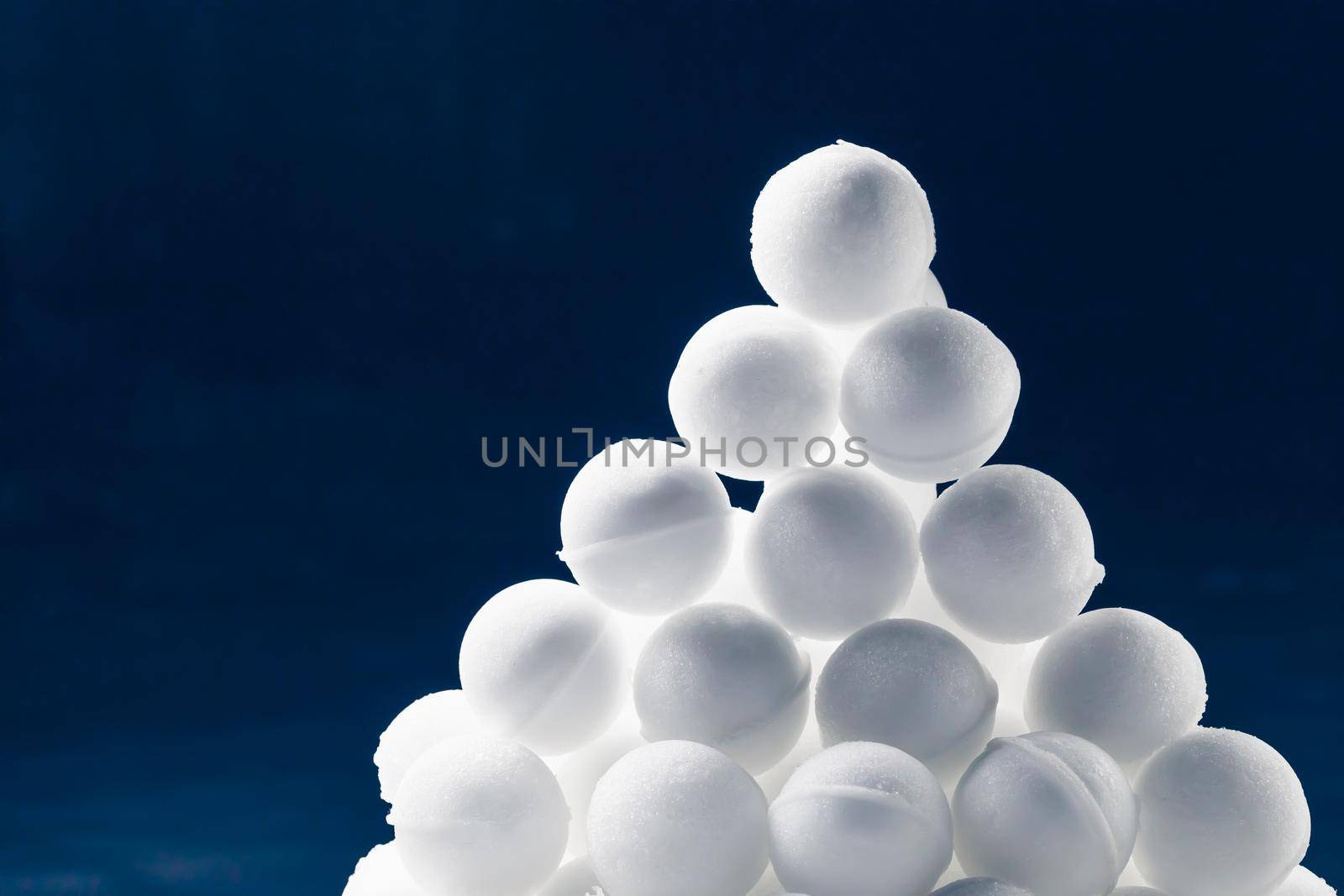 snowballs heap on dark blue background