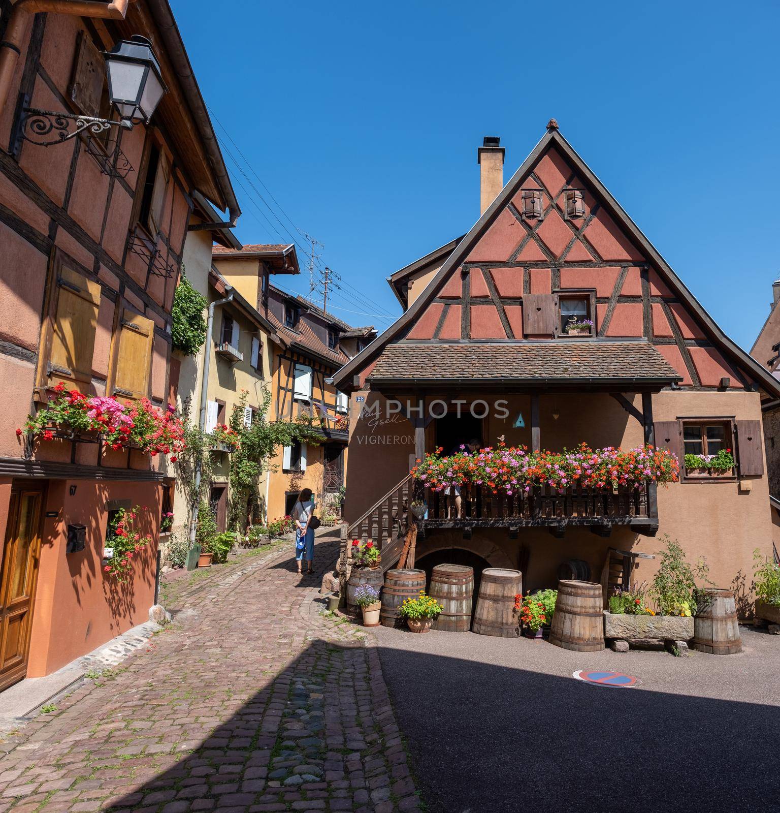 Eguisheim, Alsace, France July 2021, Traditional colorful halt-timbered houses in Eguisheim Old Town on Alsace Wine Route, France.colorful streets old town