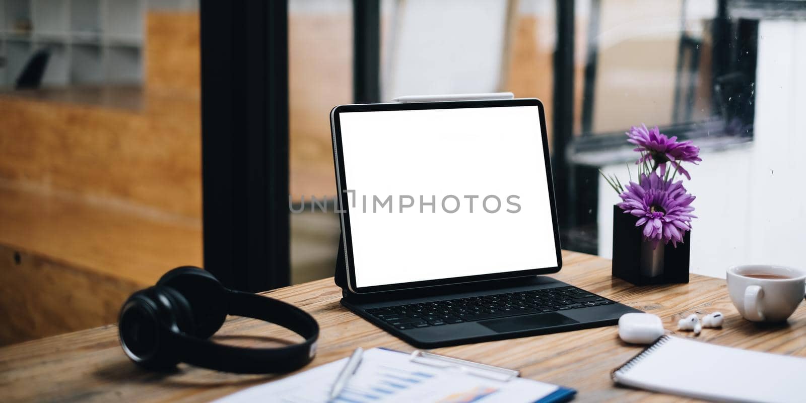 Image of Mock up digital tablet on wooden desk in office by itchaznong