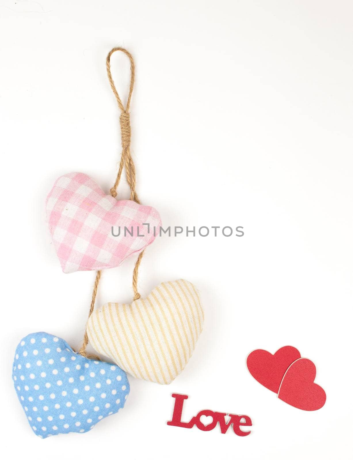 Valentine's day card. Top view cute composition with handmade fabric red hearts on white paper background. Happy birthday or anniversary congratulation. Romantic message template with copy space. by inxti