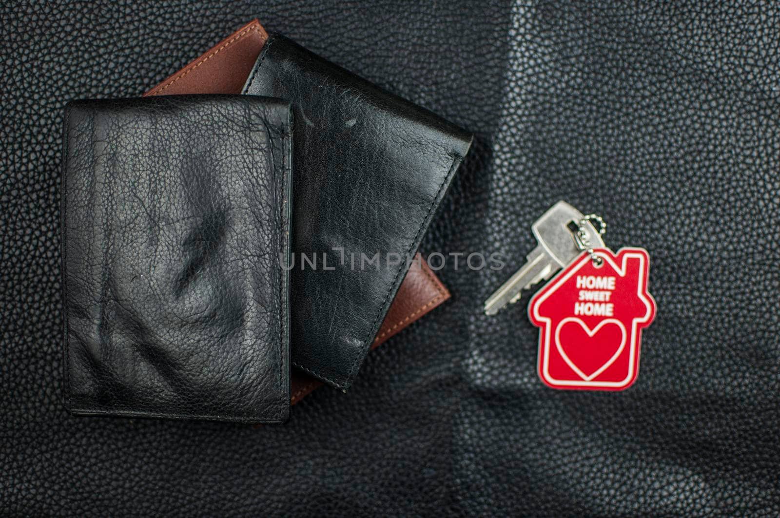 Stylish leather wallets on black leather background