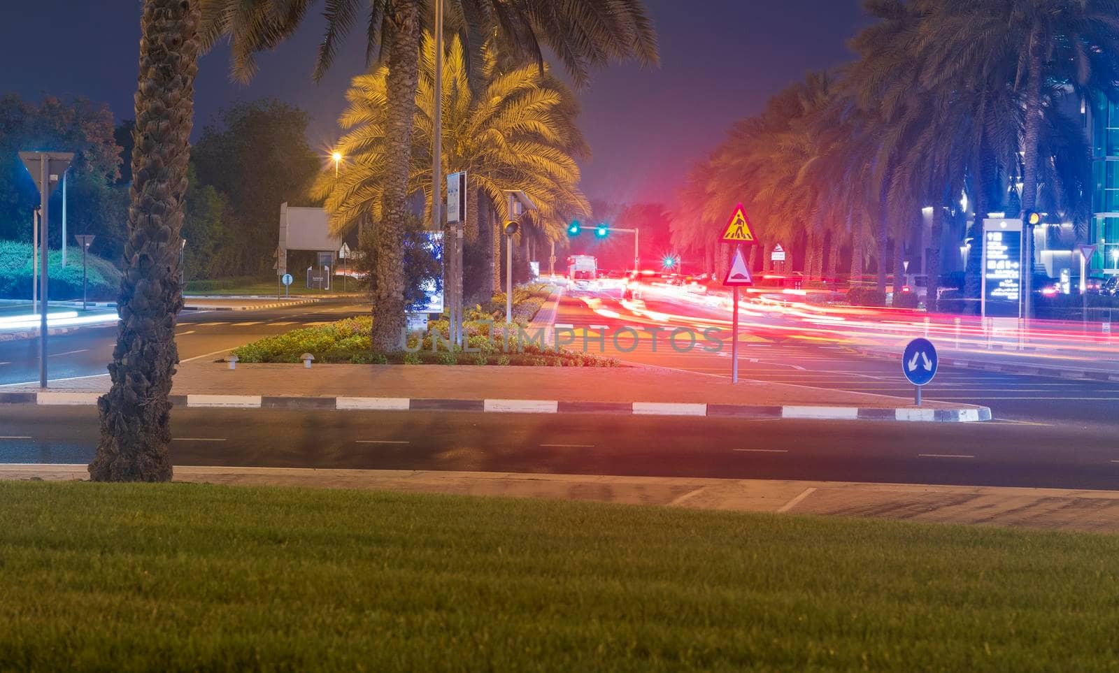 Dubai, UAE - 05.28.2021 Night street with light trails from the cars at Dubai International Financial center