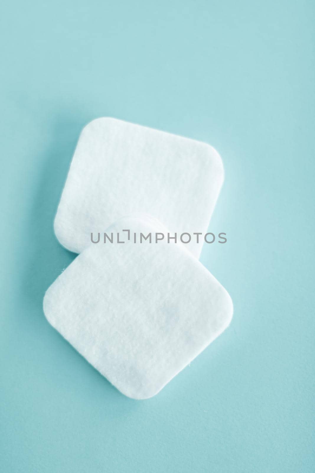 Cosmetology, cleanliness and branding concept - Organic cotton pads on mint background, cosmetics and make-up remover, hygiene and skincare beauty brand product for healthcare and medical design