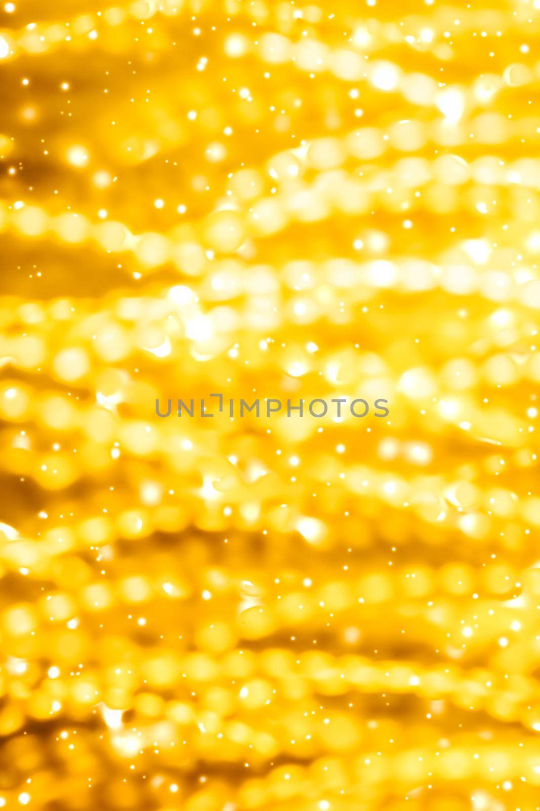 Golden Christmas lights, New Years Eve fireworks and abstract texture concept - Glamorous gold shiny glow and glitter, luxury holiday background