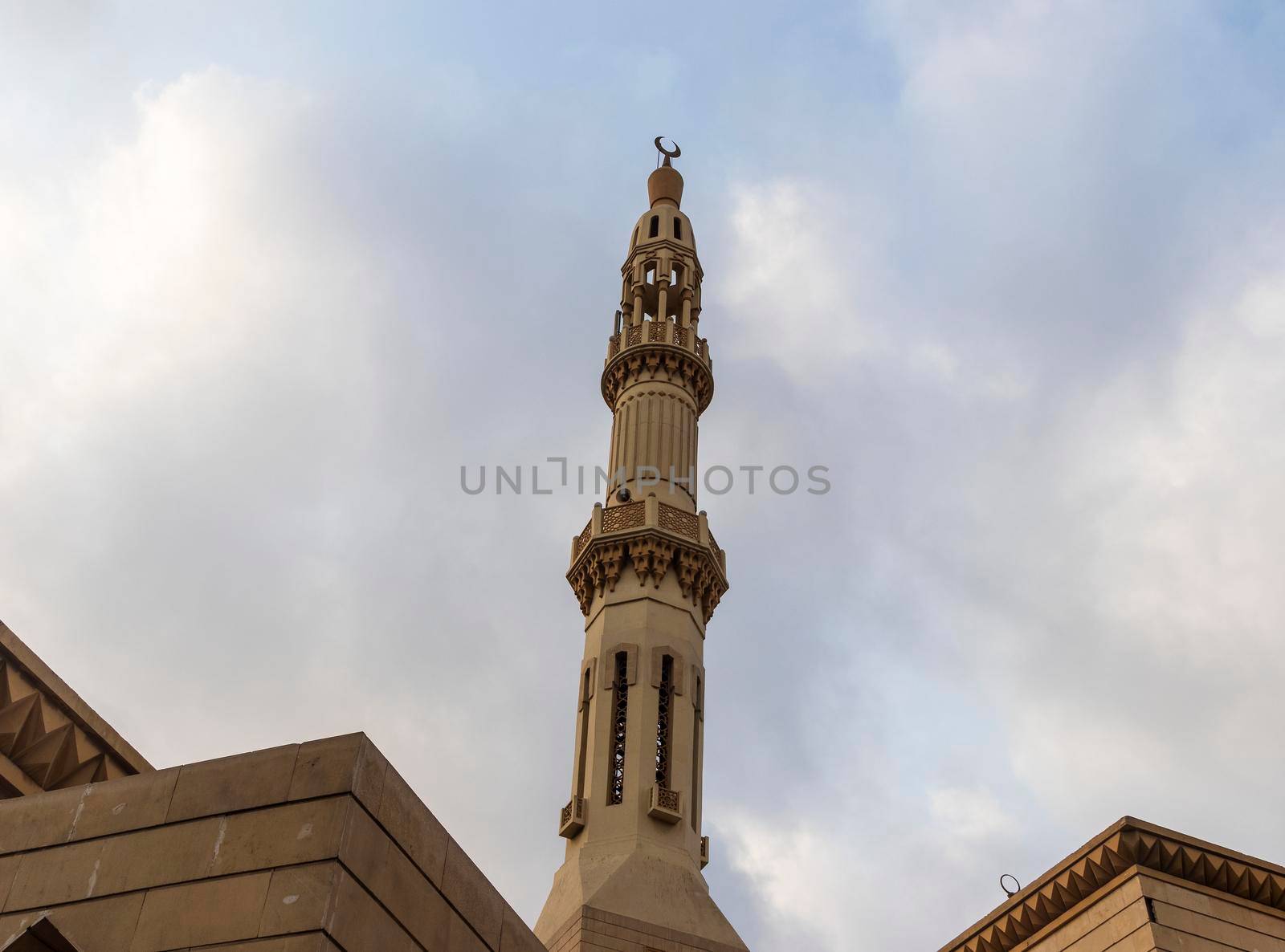 Shot of a minaret with cloudy sky on background