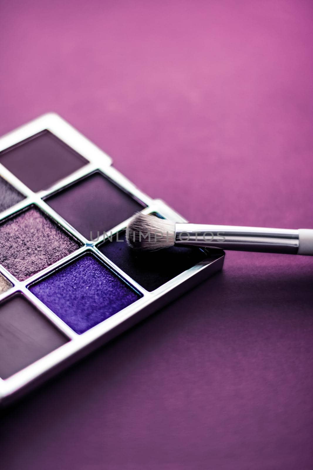 Cosmetic branding, mua and girly concept - Eyeshadow palette and make-up brush on purple background, eye shadows cosmetics product as luxury beauty brand promotion and holiday fashion blog design