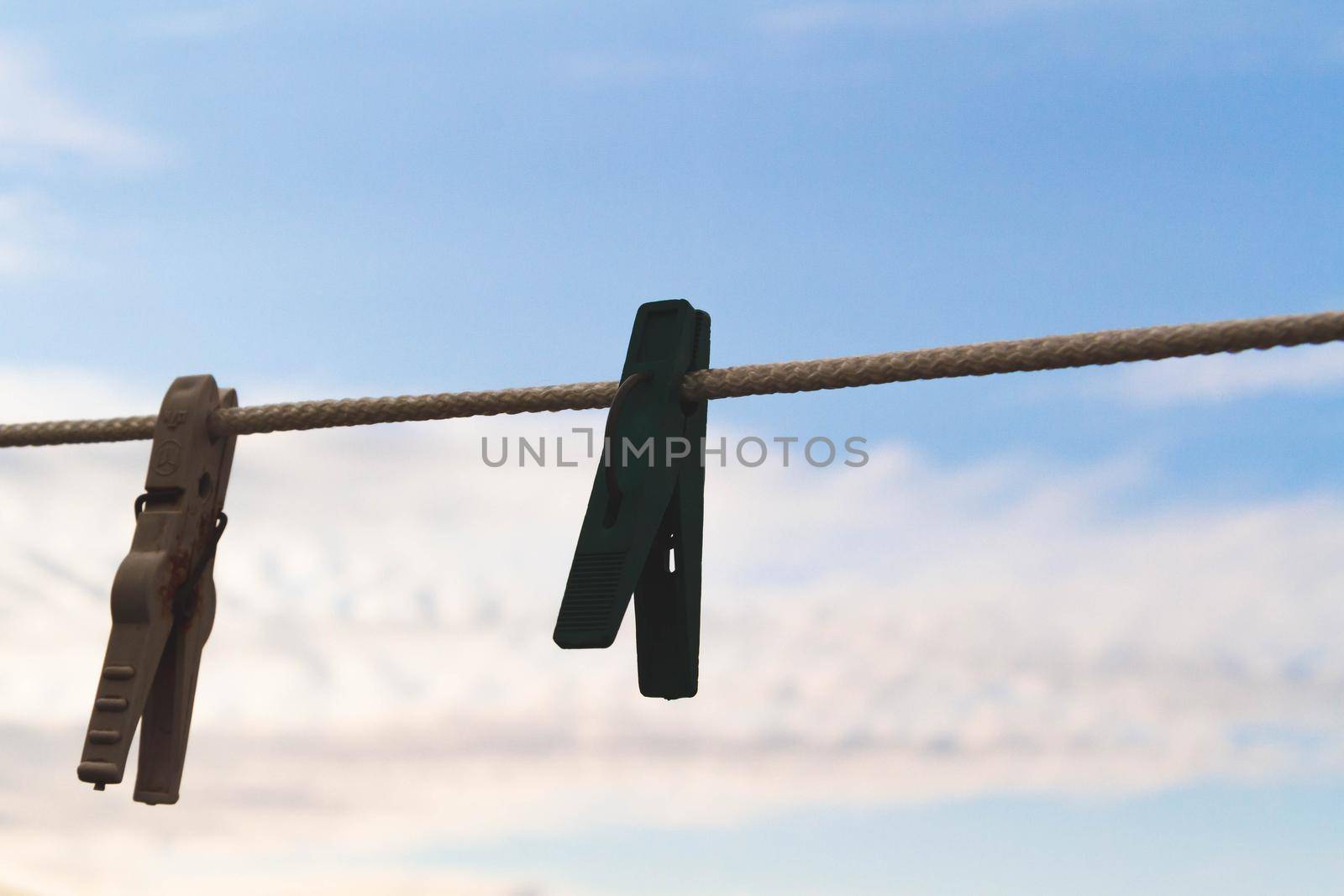 Clothespins for drying clothes on a rope. Clothesline . by Verrone