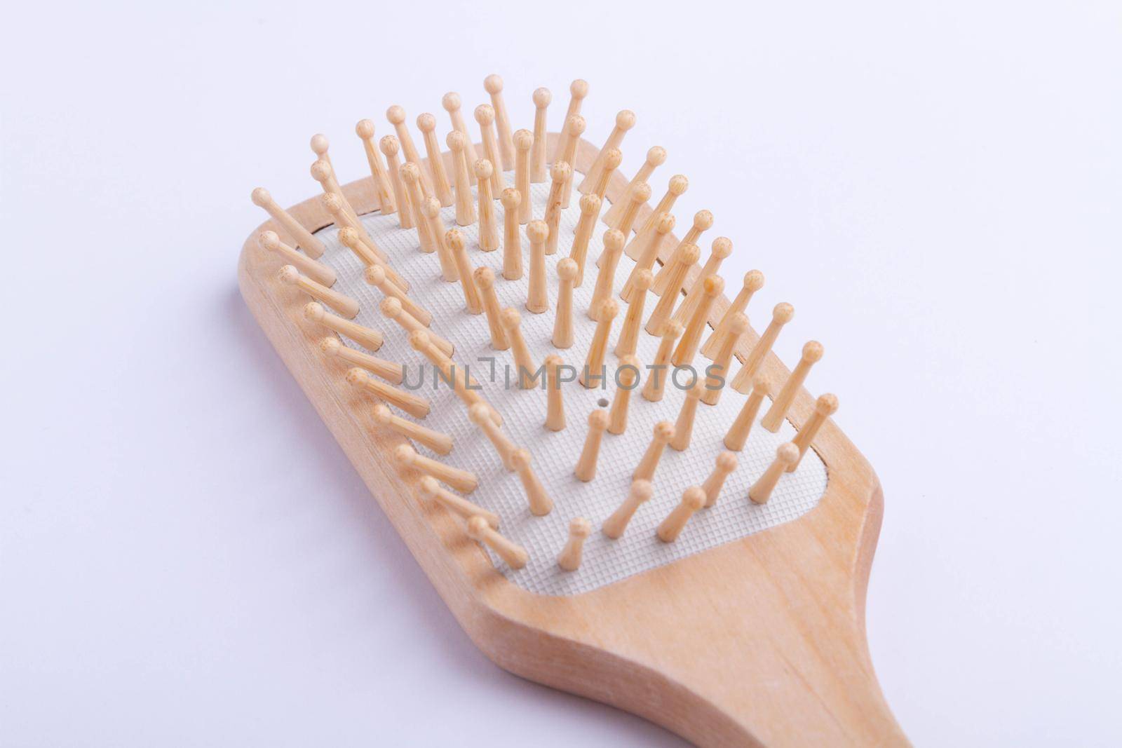 Massage comb to stimulate hair growth. Comb on isolated background. Beauty and hair care.