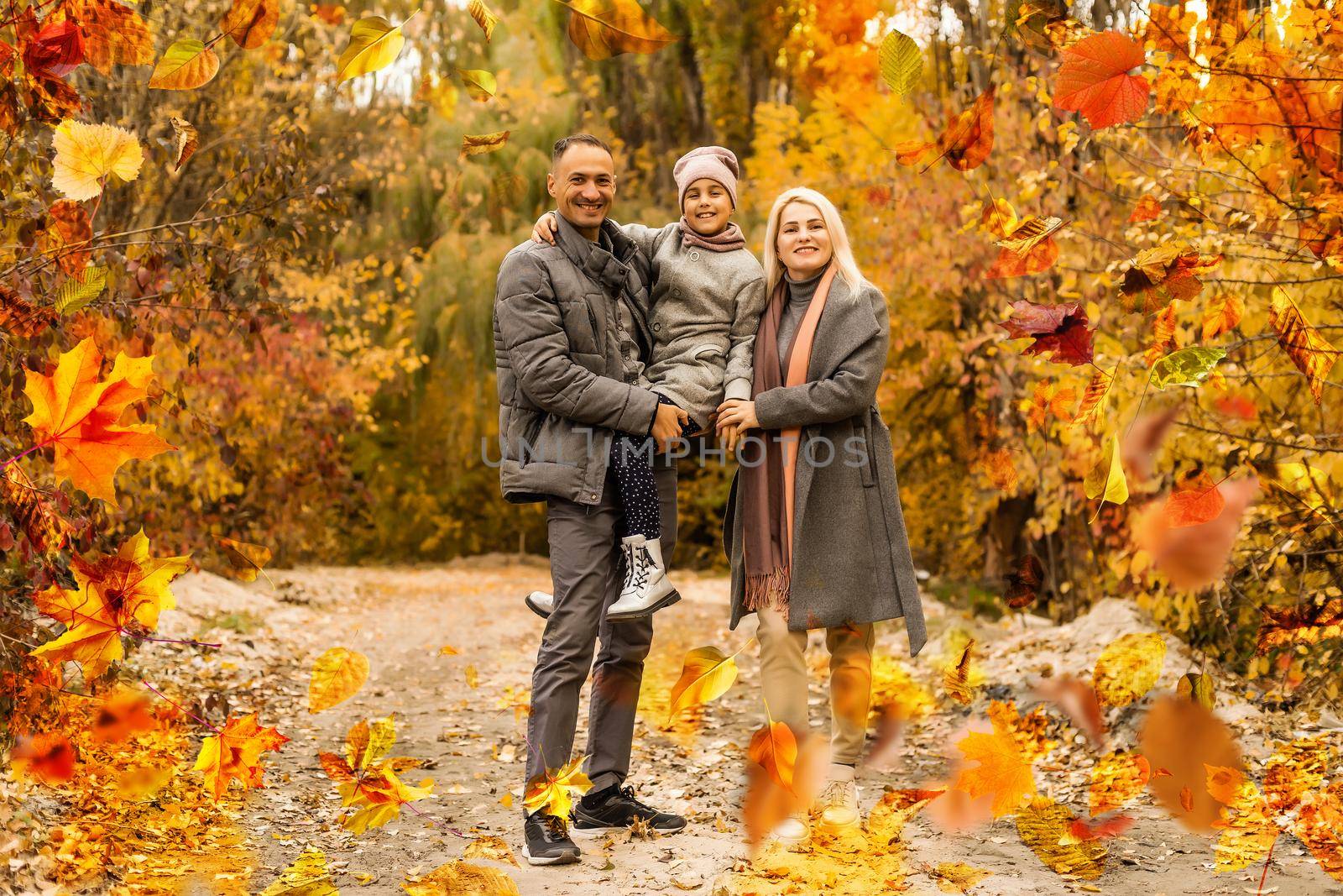 Family playing in autumn park having fun by Andelov13