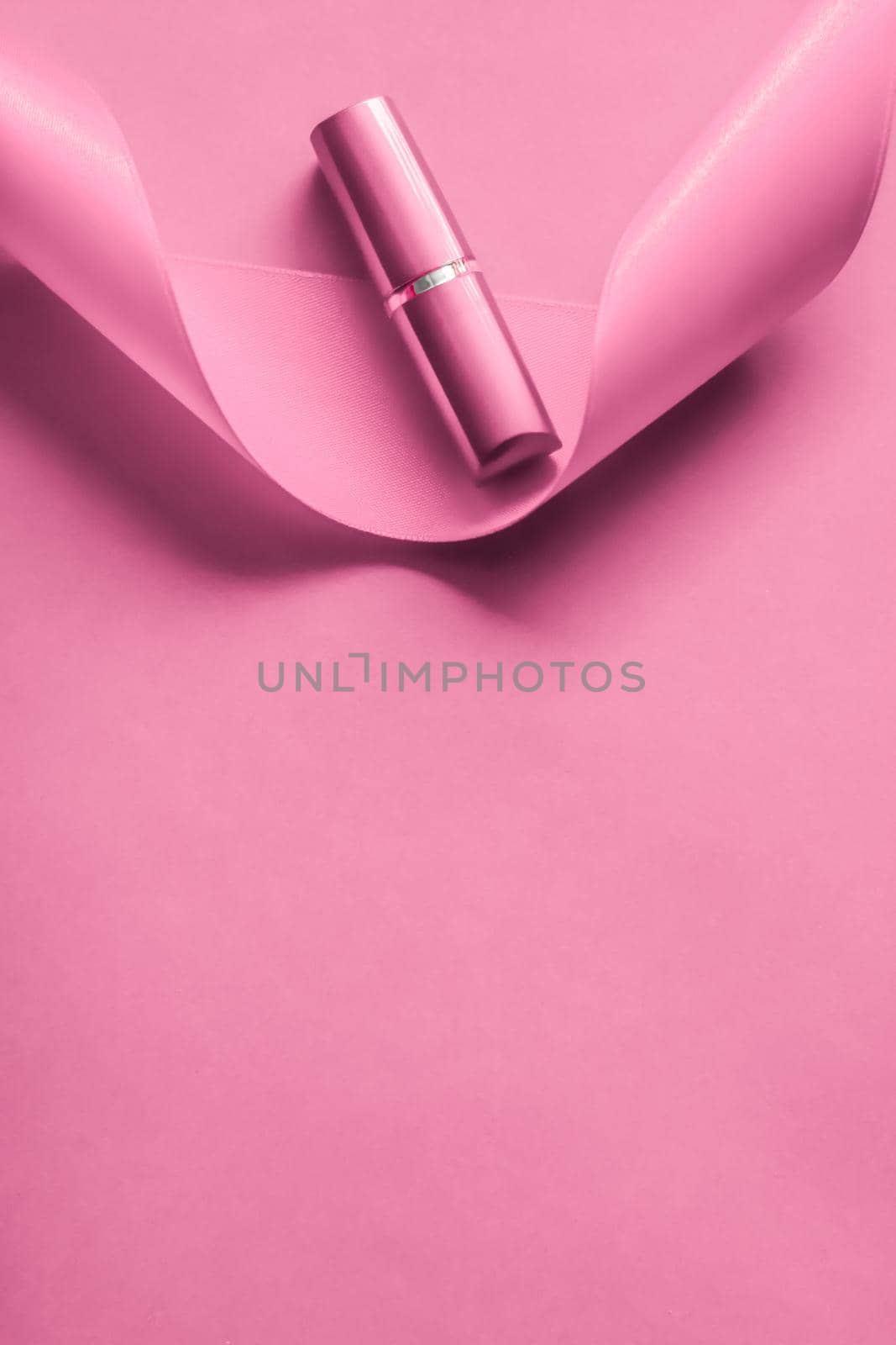 Luxury lipstick and silk ribbon on pink holiday background, make-up and cosmetics flatlay for beauty brand product design by Anneleven