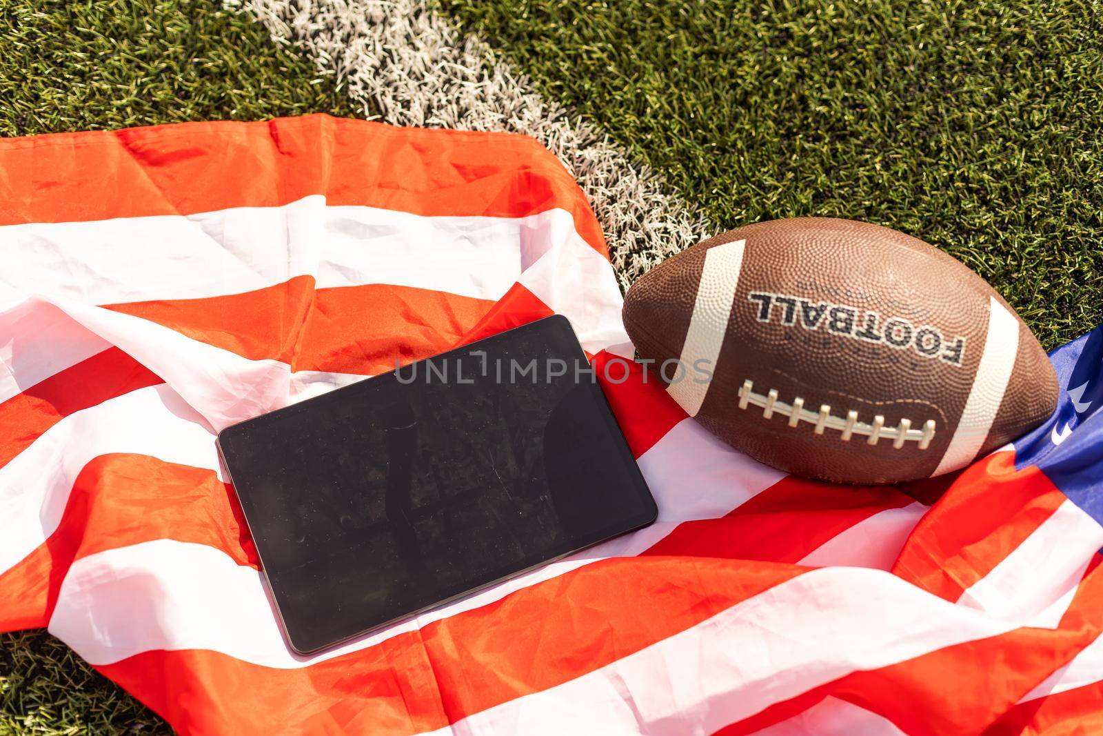 american football ball and tablet, american flag.