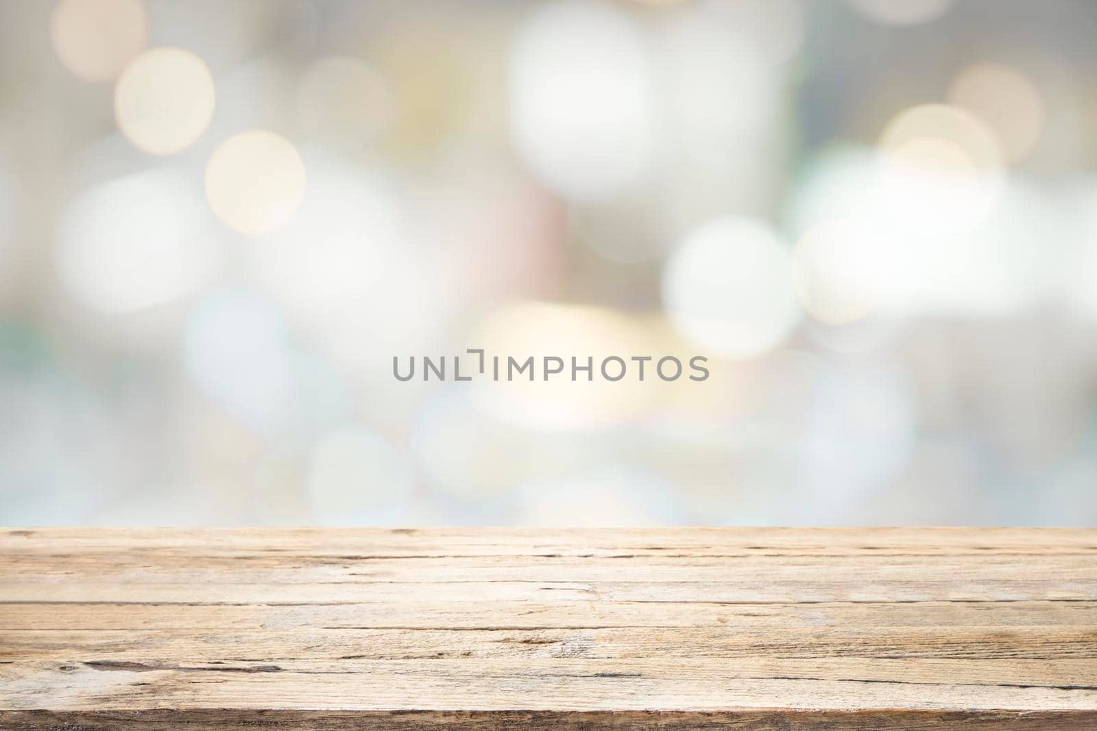 Empty wooden table for present product on coffee shop or soft drink bar blur background with bokeh image.
