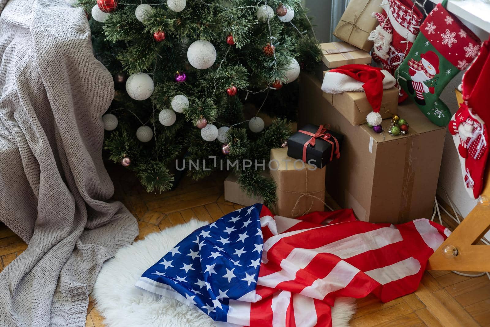 Close-up of gift boxes and a Christmas tree with an American flag in the background. Space for text. Concept of Christmas and new year festival. by Andelov13