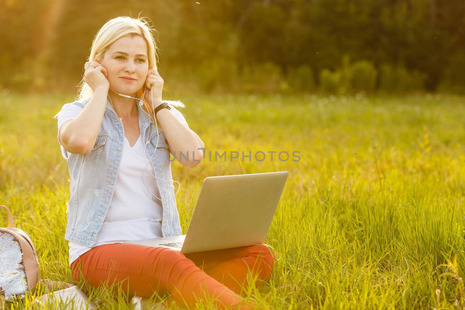 Euphoric woman searching job with a laptop in an urban park in summer. by Andelov13