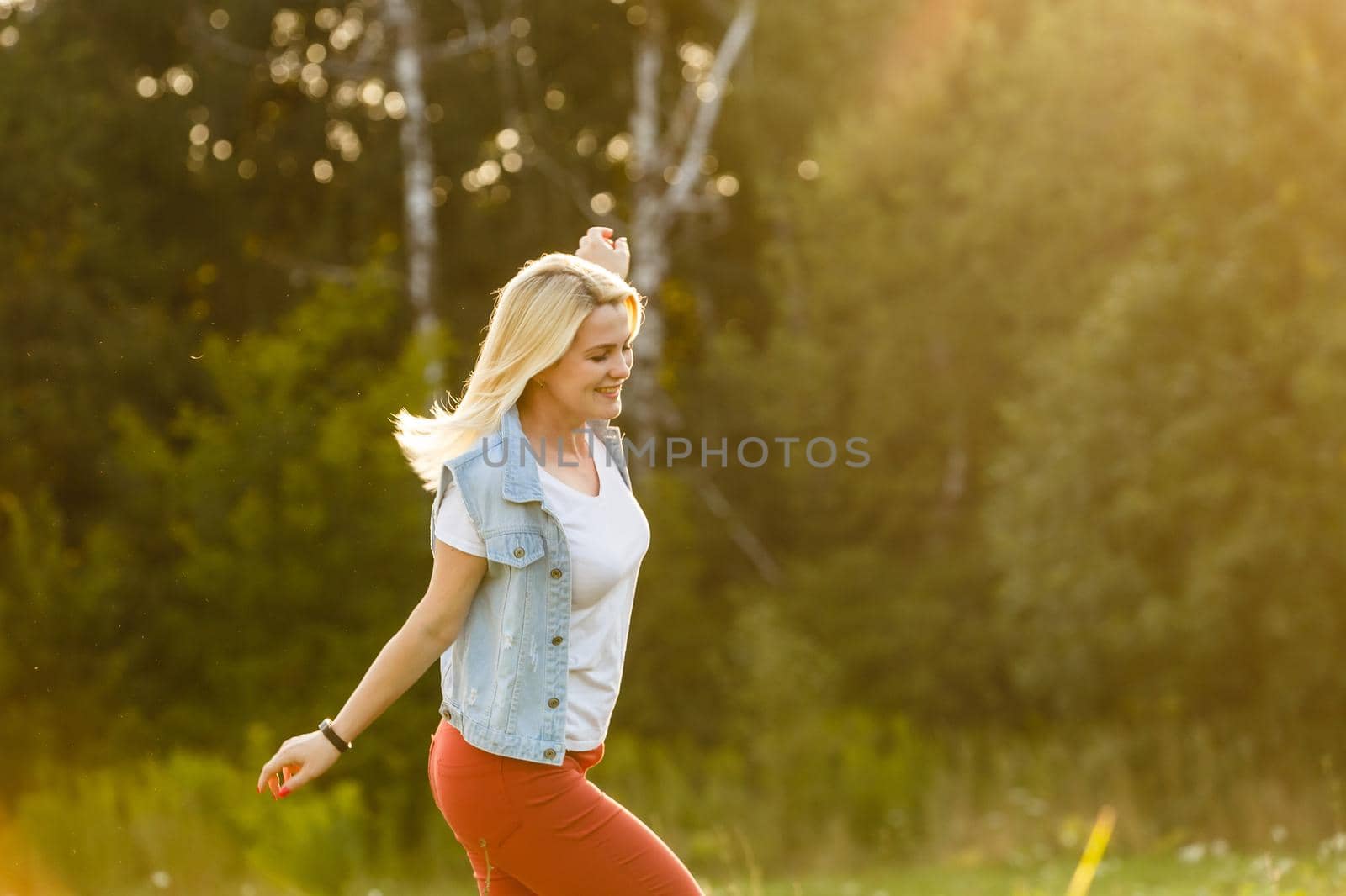 Free Happy Woman Enjoying Nature. Beauty Girl Outdoor. Freedom concept. Beauty Girl over Sky and Sun. Sunbeams. Enjoyment.