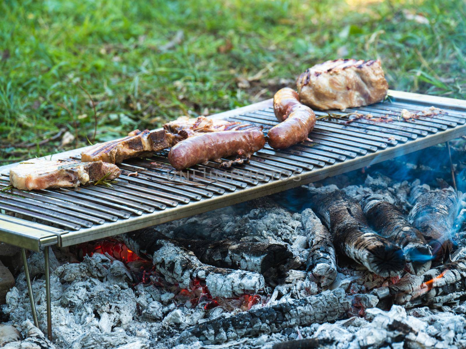 cooking pork meat in the grill outdoors with charcoal