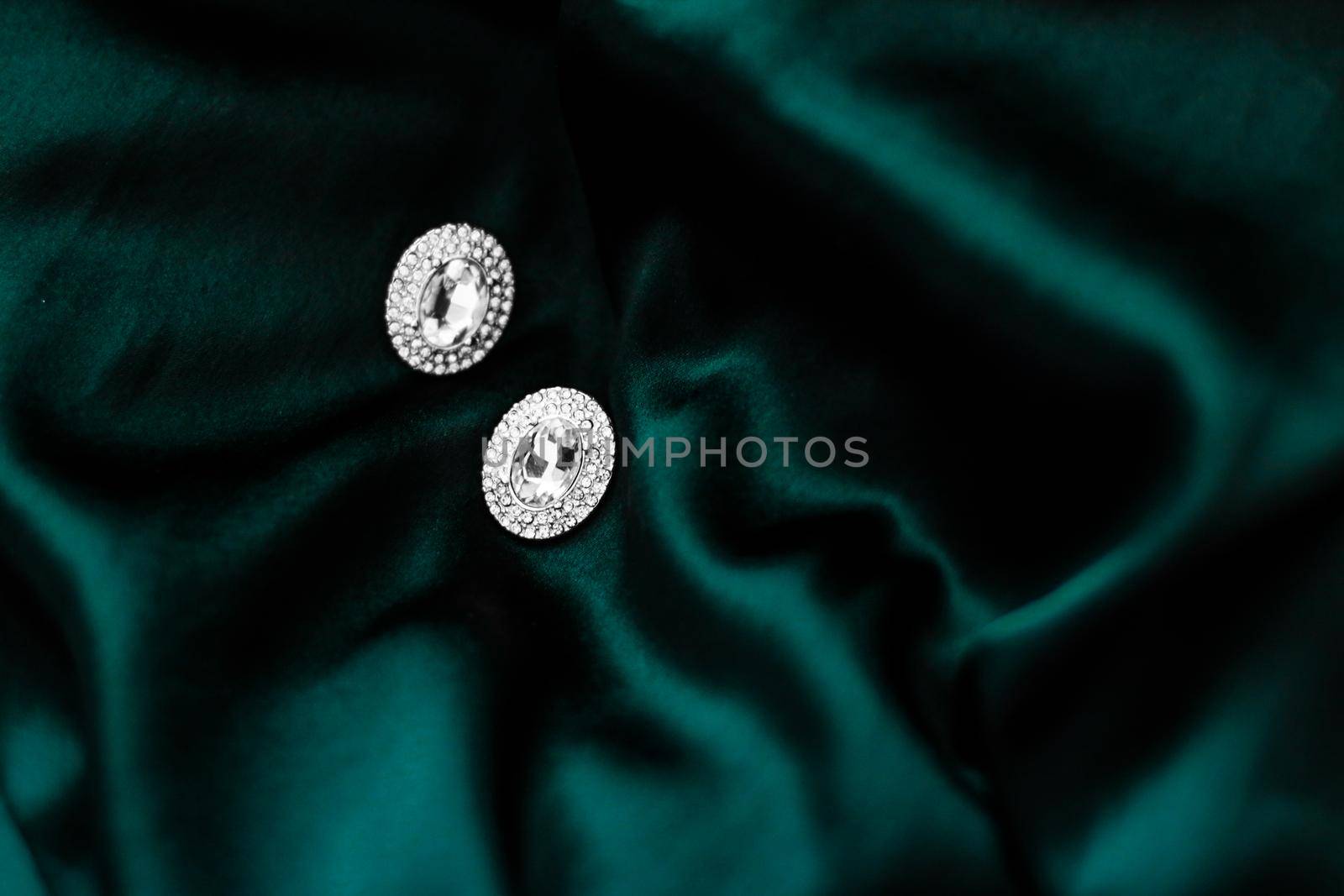 Jewellery brand, elegant fashion and bridal luxe gift concept - Luxury diamond earrings on dark emerald green silk, holiday glamour jewelery present