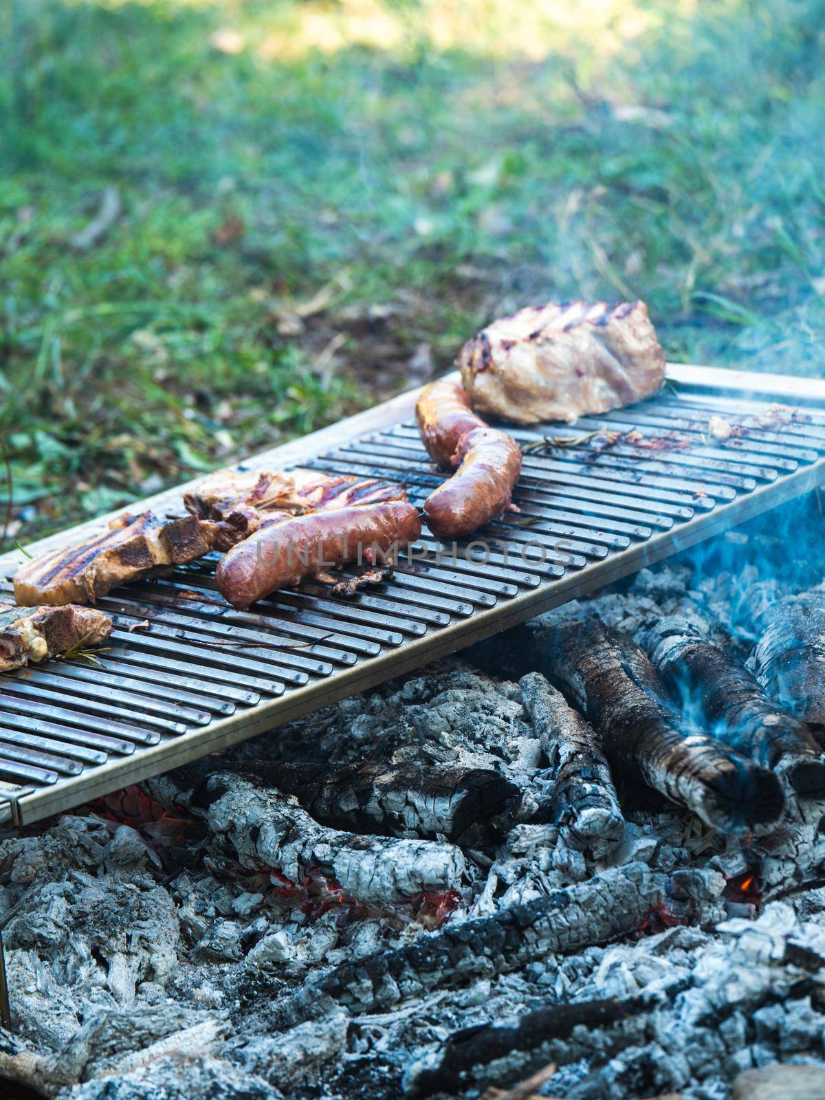 cooking pork meat in the grill outdoors with charcoal