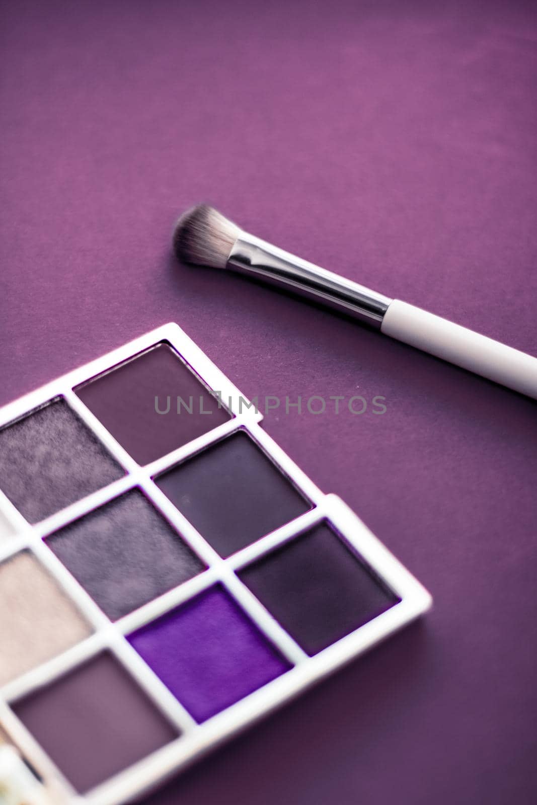 Eyeshadow palette and make-up brush on purple background, eye shadows cosmetics product as luxury beauty brand promotion and holiday fashion blog design by Anneleven