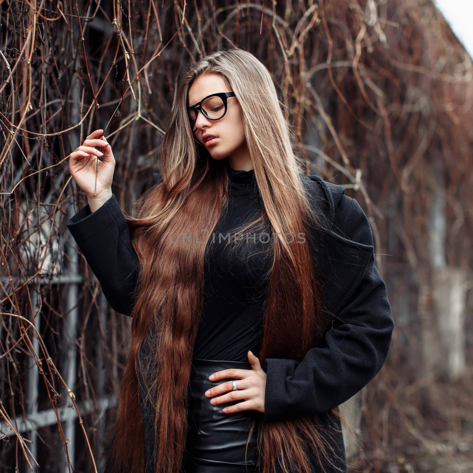 Young beautiful fashionable woman with long hair dream by OnPhotoUa