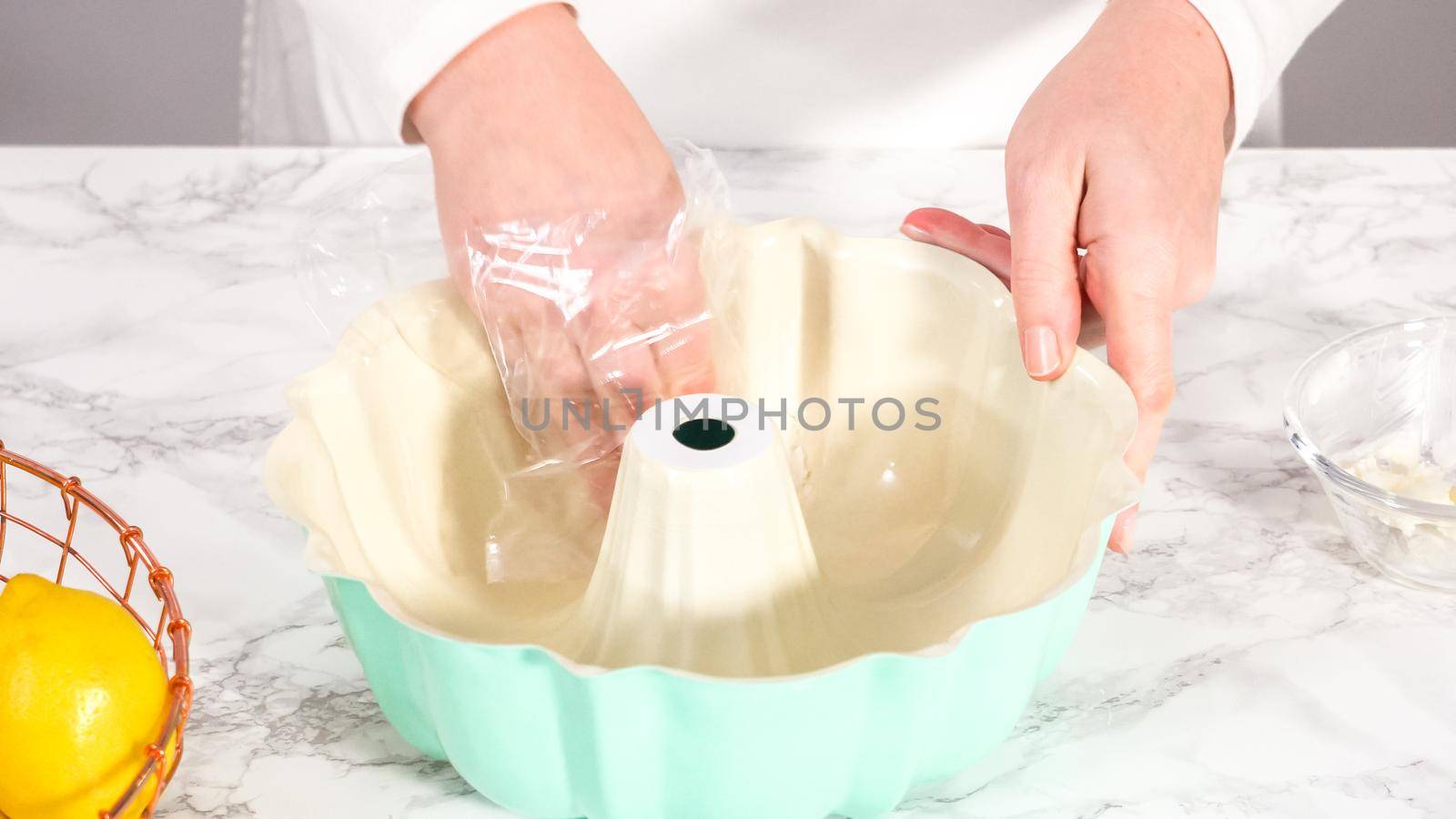 Step by step. Greasing bundt cake pan with vegetable shortening and sprinkling with white flour.