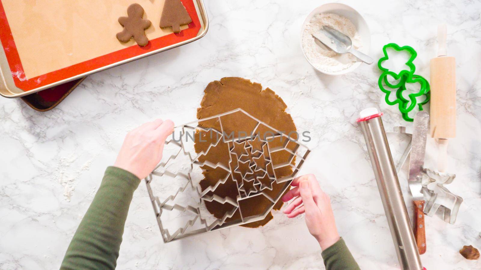 Flat lay. Step by step. Cutting out shapes with Christmas cookies cutter from gingerbread cookie dough.