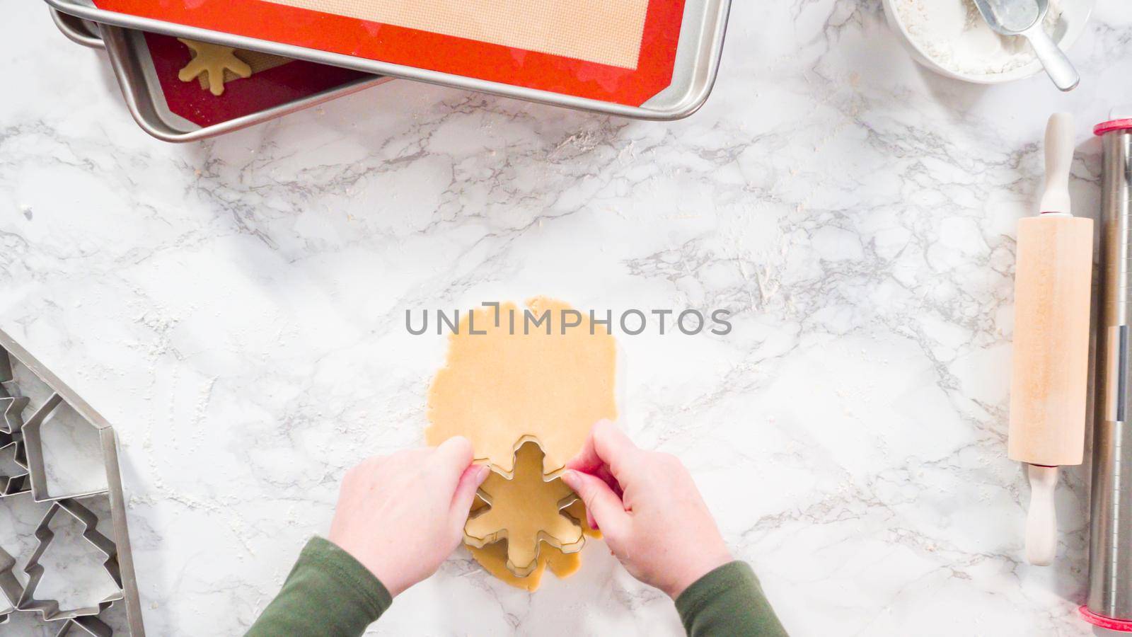 Flat lay. Step by step. Cutting out shapes with Christmas cookies cutter from sugar cookie dough.