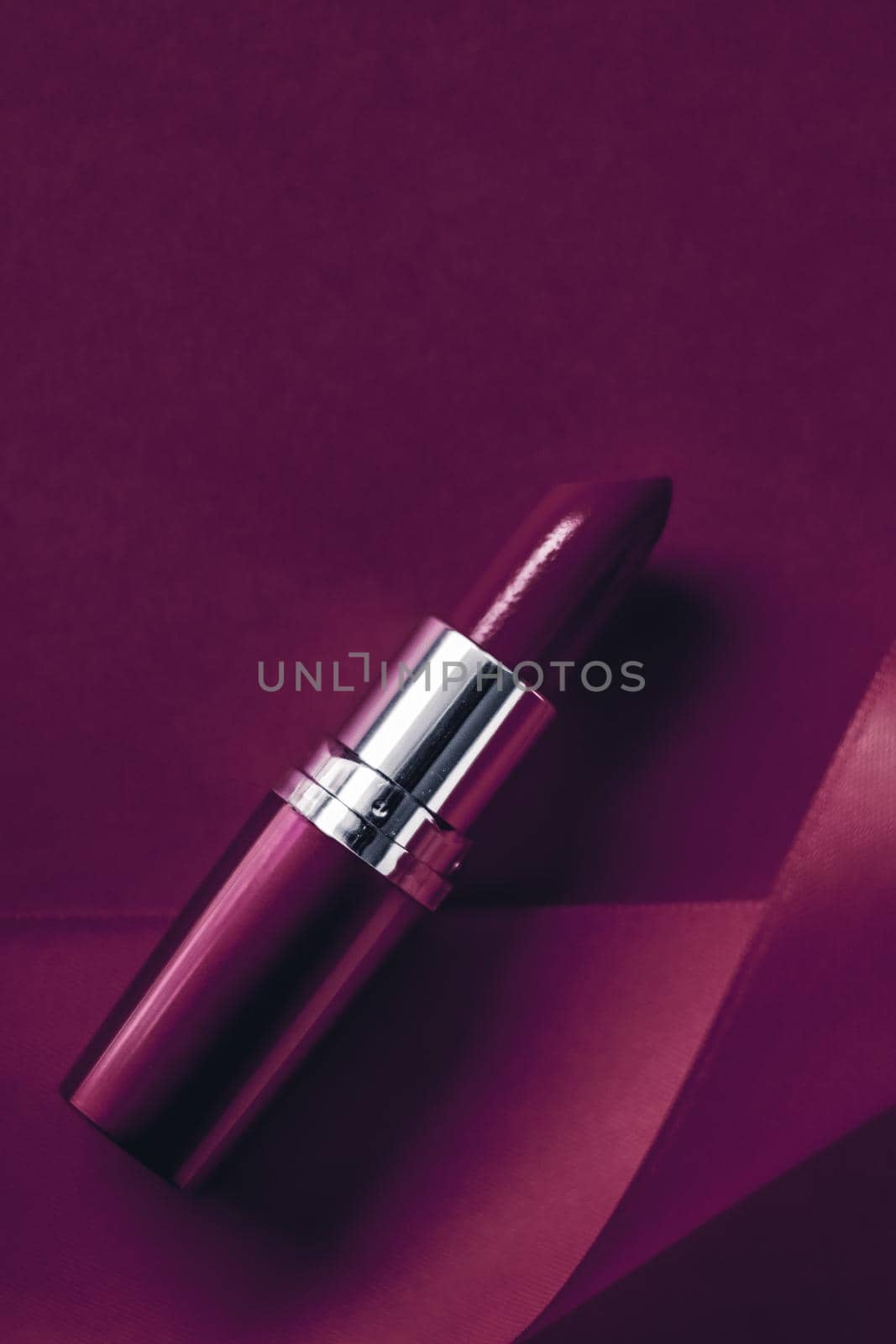 Cosmetic branding, glamour lip gloss and shopping sale concept - Luxury lipstick and silk ribbon on plum holiday background, make-up and cosmetics flatlay for beauty brand product design