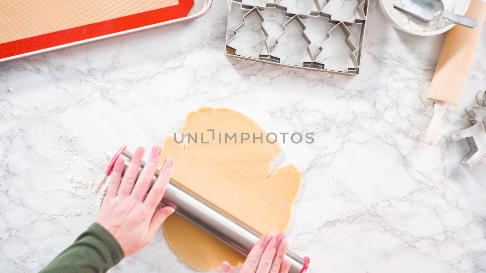 Flat lay. Step by step. Rolling out sugar cookie dough to bake Christmas cookies.