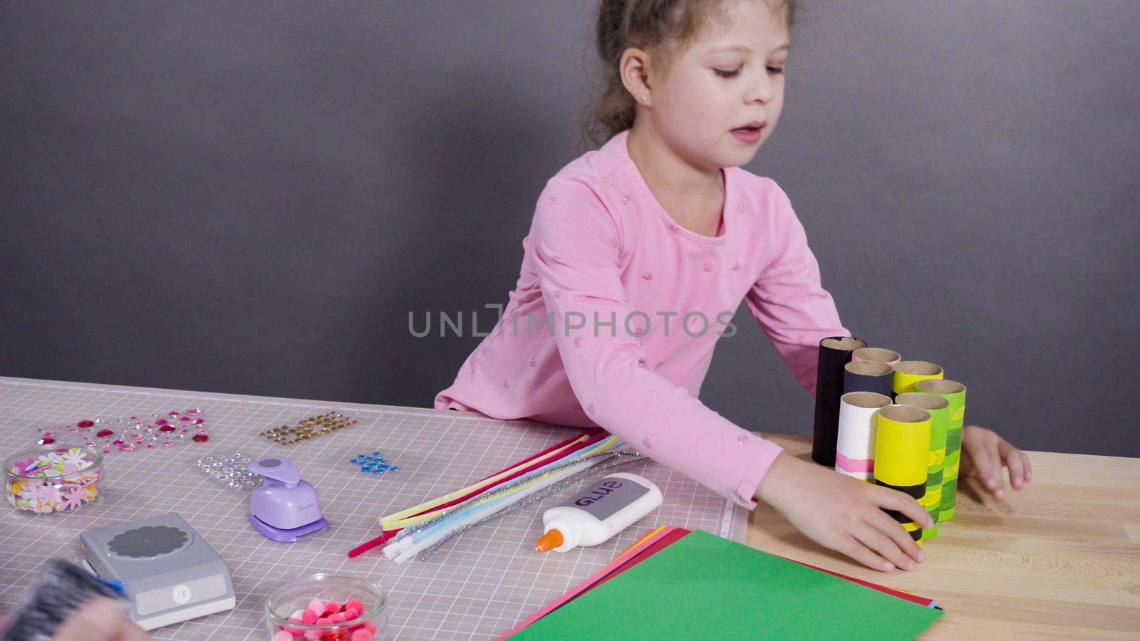 Kids papercraft. Making paper bugs out of the empty toilet paper rolls and construction paper.