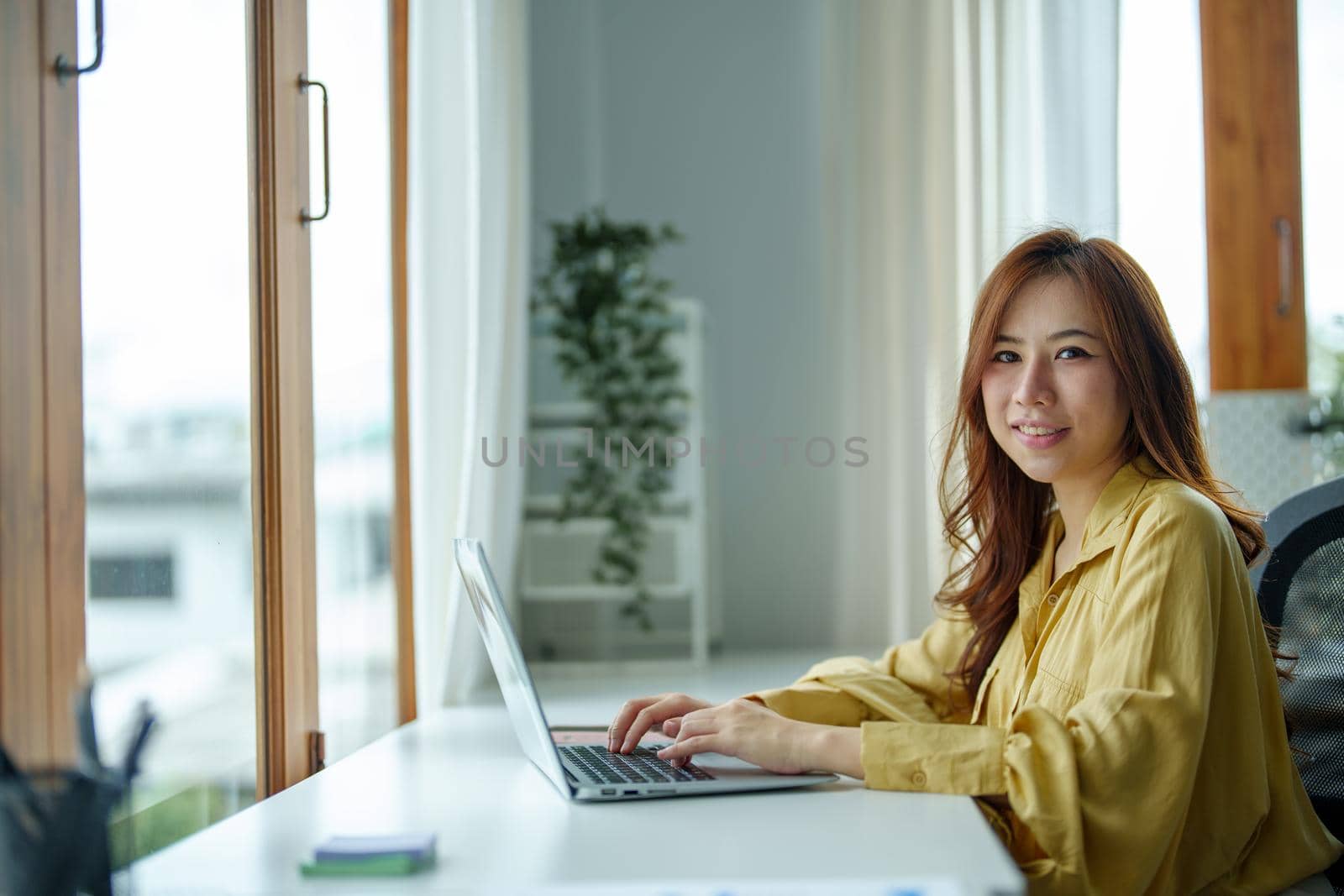 Portrait of a business woman, accountant, marketer, showing a smiling face during the start of a new morning before working.