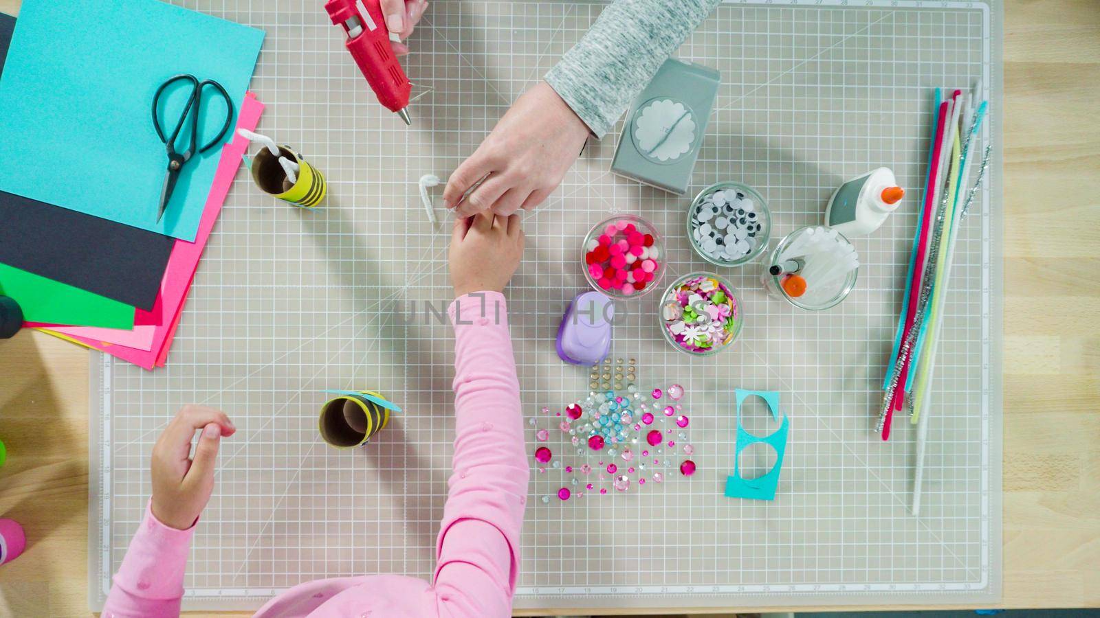 Flat lay. Kids papercraft. Making paper bugs out of the empty toilet paper rolls and construction paper.