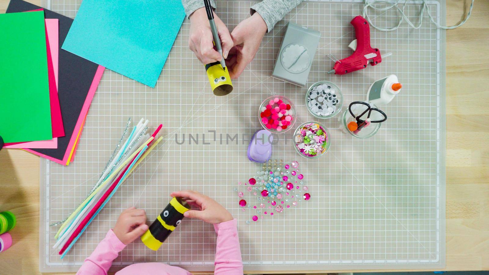 Flat lay. Kids papercraft. Making paper bugs out of the empty toilet paper rolls and construction paper.