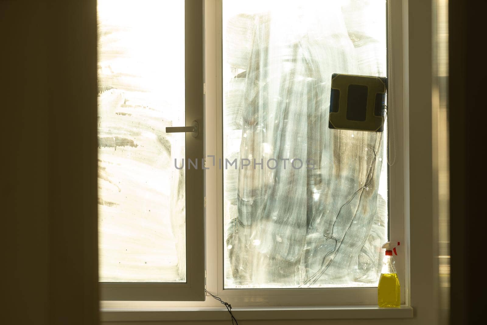 Window with very dirty and dusty glass in daylight. cleaning robot by Andelov13