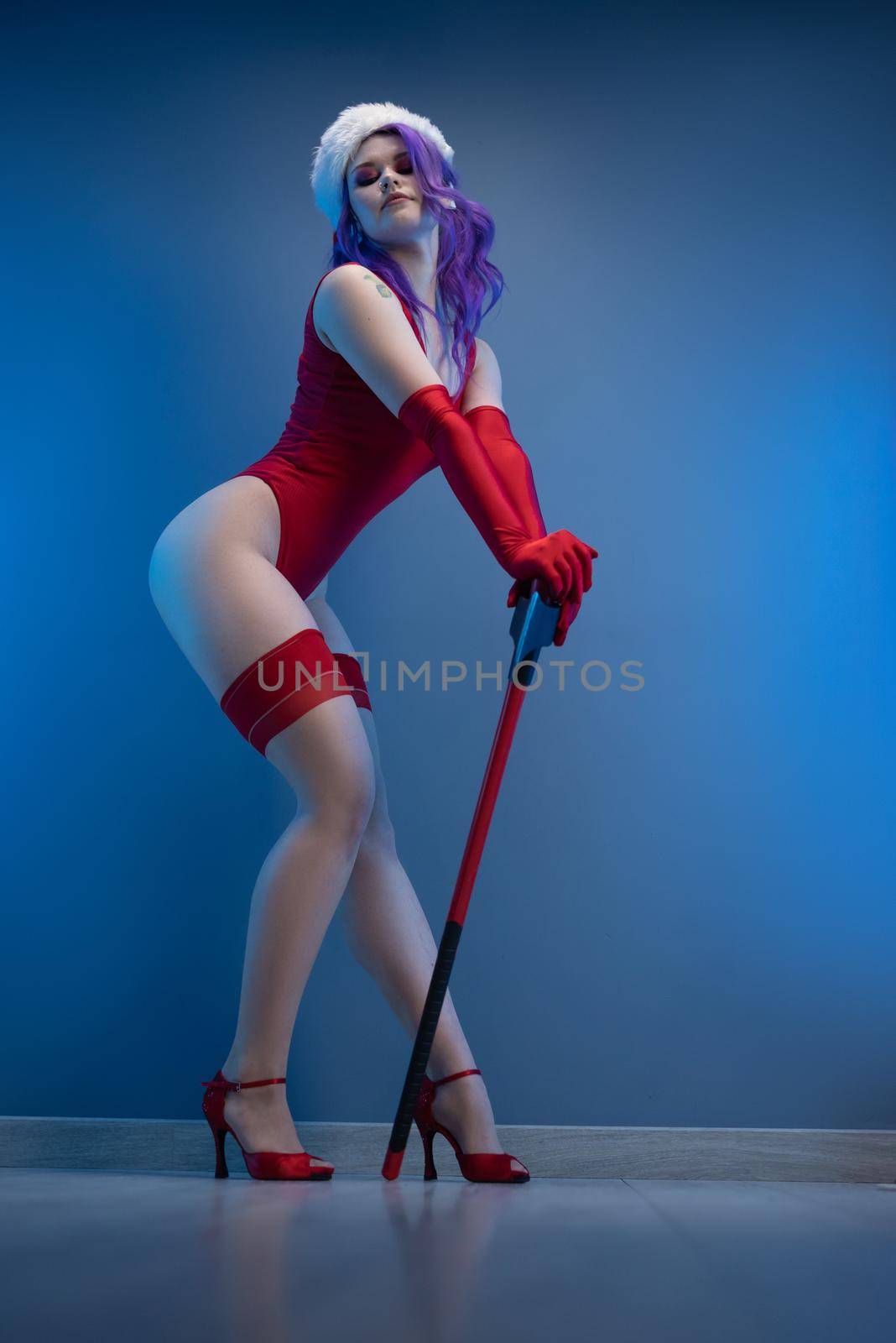 sexy girl in red underwear and santa hat with an axe on a blue background by Rotozey